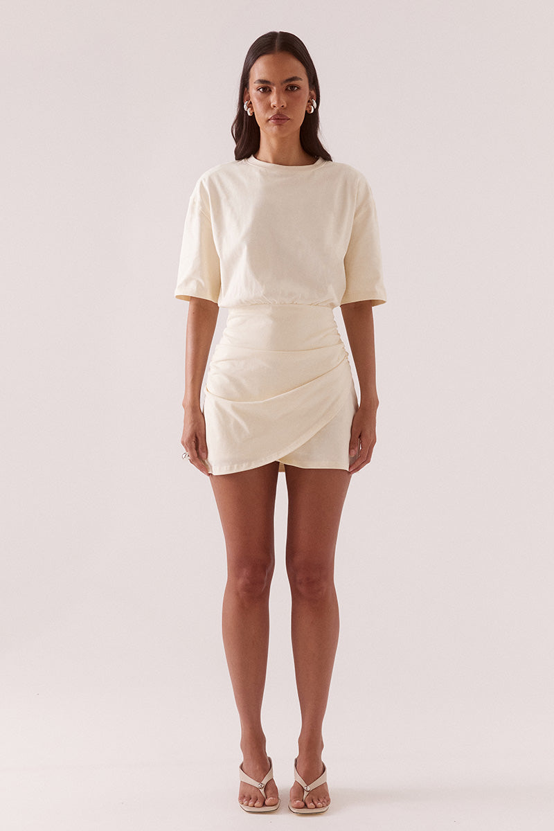 Women’s oversized cotton tee mini dress with dropped shoulders, crew neck, wrap skirt detail, soft gathers at waist, and side zip closure.