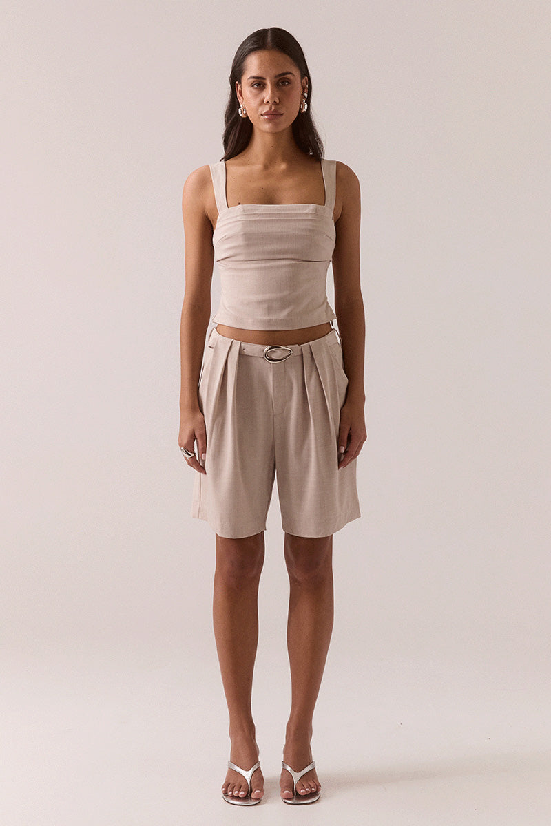 Women’s fitted top in stretchy rayon blend with balconette neckline, layered tuck details, wide adjustable straps, deep underbust tuck, and back zipper closure.