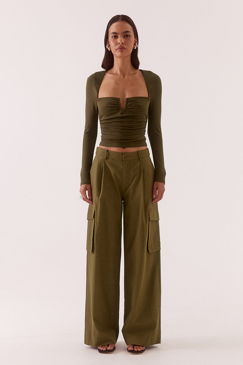 Women’s fitted long sleeve top in rayon blend with front bust cut-out, built-in wire support, gathered bust and waist, and elastic armholes