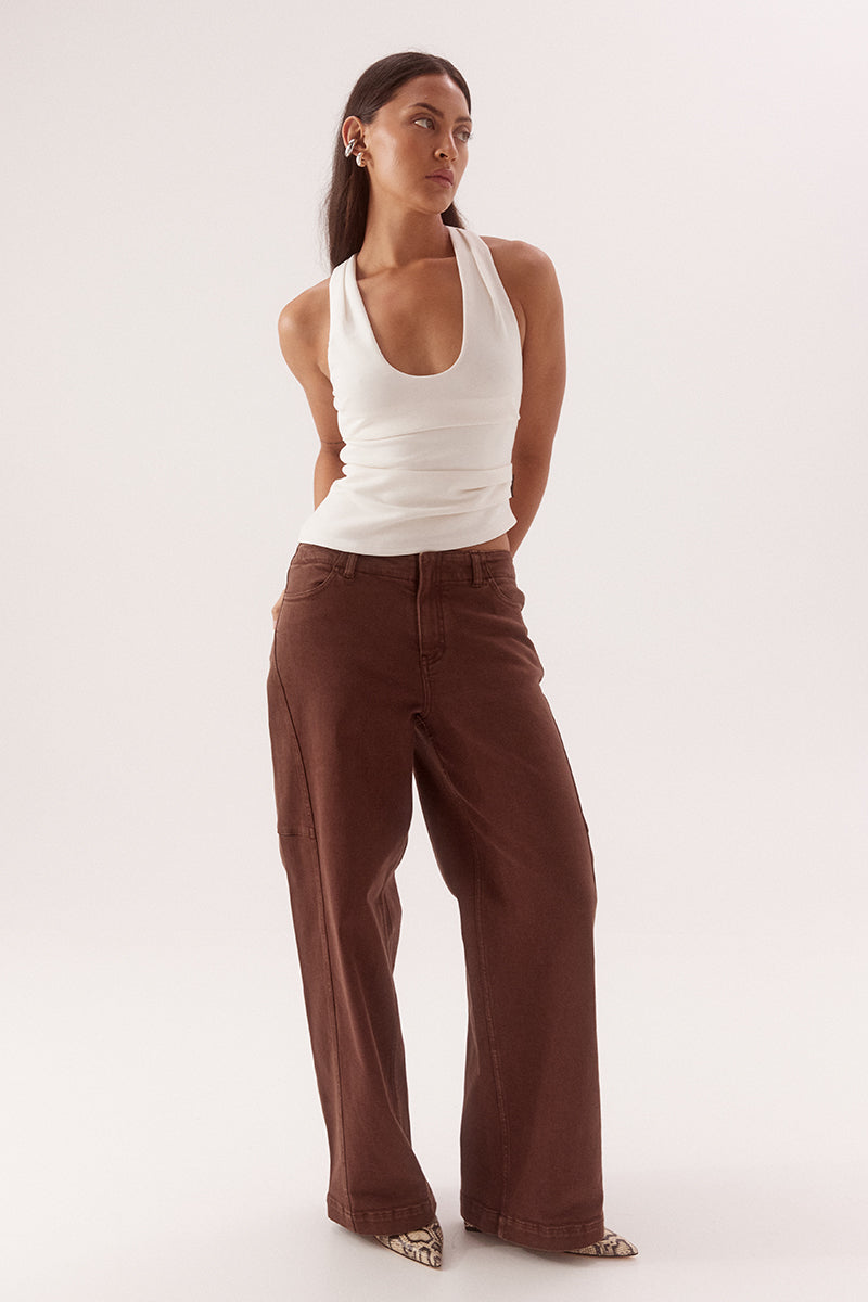 Women's viscose blend sleeveless top with deep scoop neckline, racer back, shoulder tucks, asymmetric hem and stretch lining.