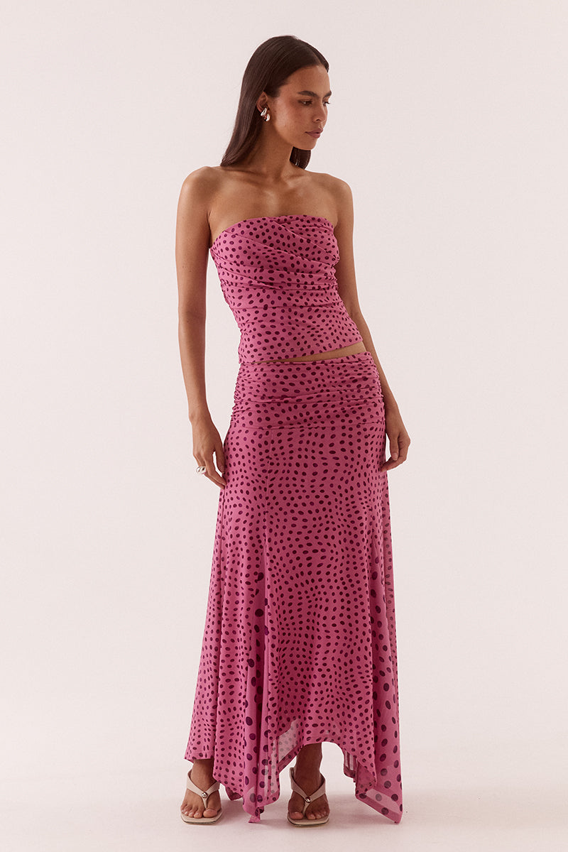 Model wearing a stretch lace halter midi dress with a plunging neckline, asymmetric hem, waterfall drape panel and scalloped edging.