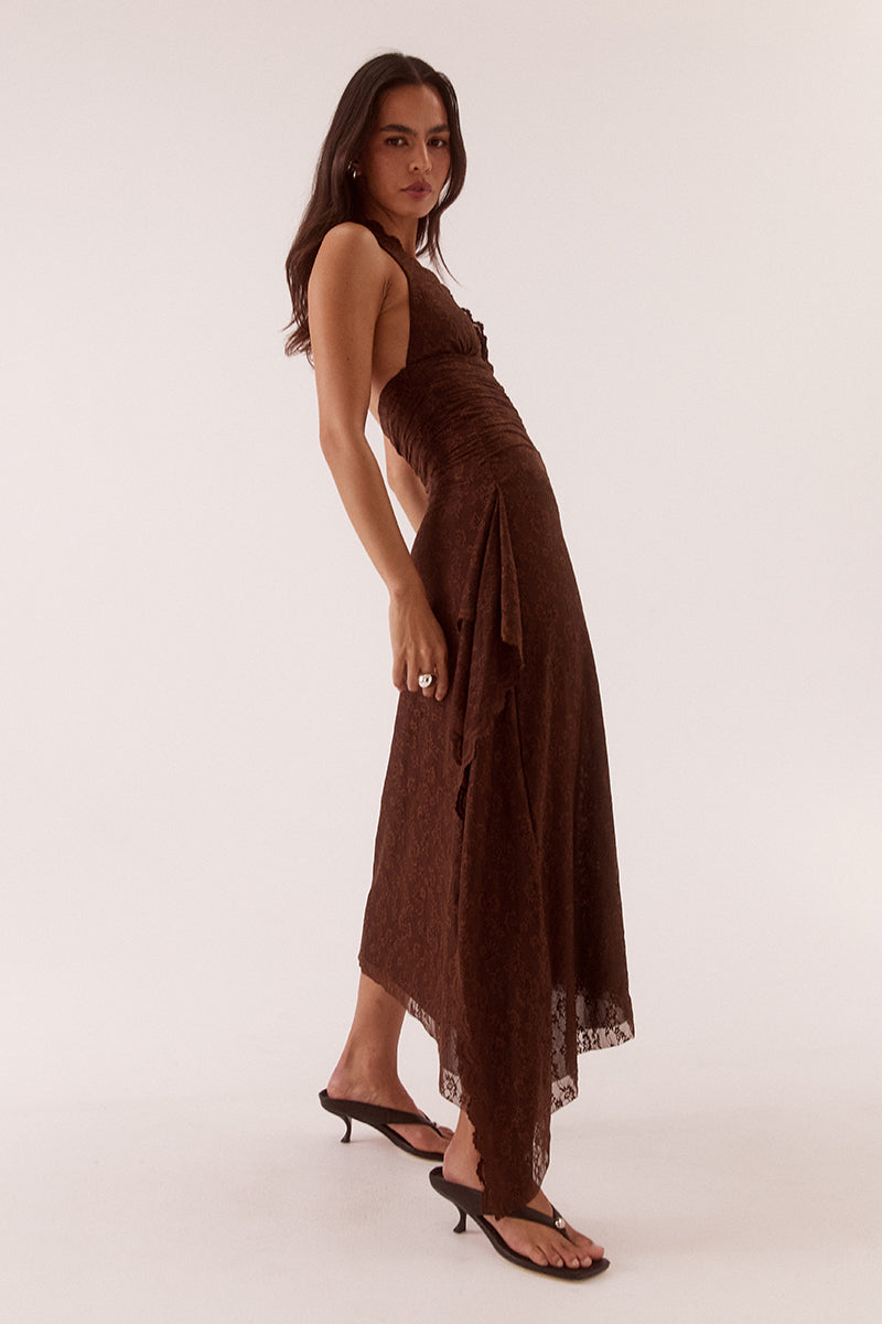 Model wearing a stretch lace halter midi dress with a plunging neckline, asymmetric hem, waterfall drape panel and scalloped edging.