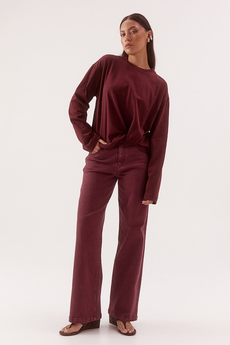 Women's oversized cotton long sleeve tee with dropped shoulders, crew neckline, and tucked front detail creating a flattering shaped hem.