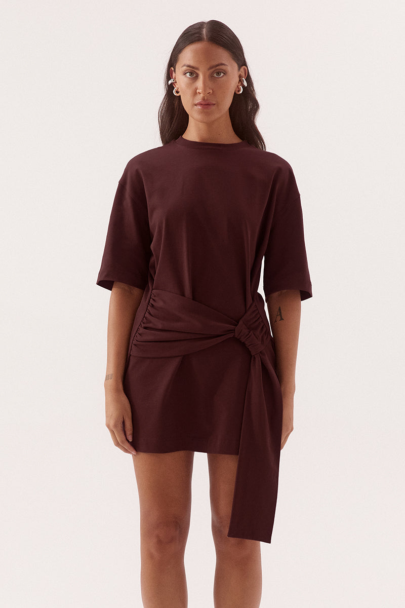 Relaxed fit 100% cotton mini T-shirt dress with crew neckline, dropped shoulders, side-gathered sash with loop detail, worn by model in size 8.