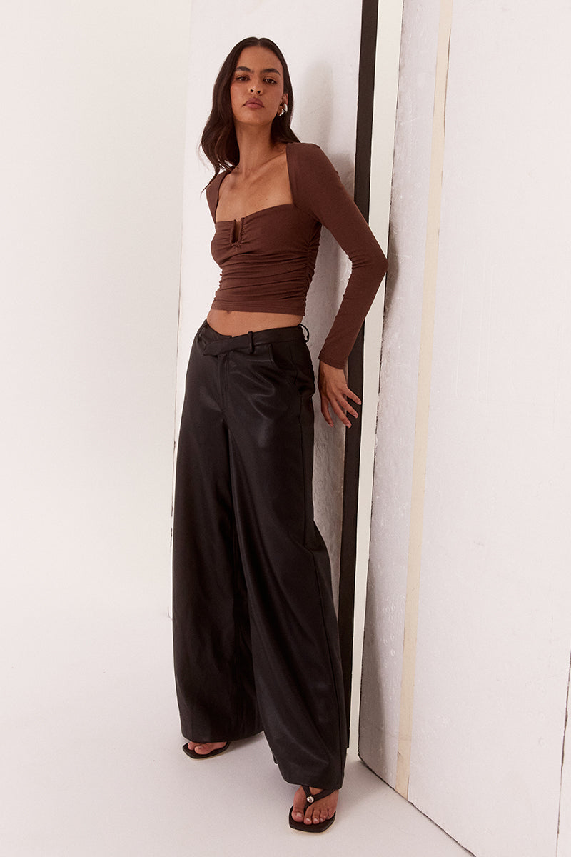 Women’s fitted long sleeve top in rayon blend with front bust cut-out, built-in wire support, gathered bust and waist, and elastic armholes