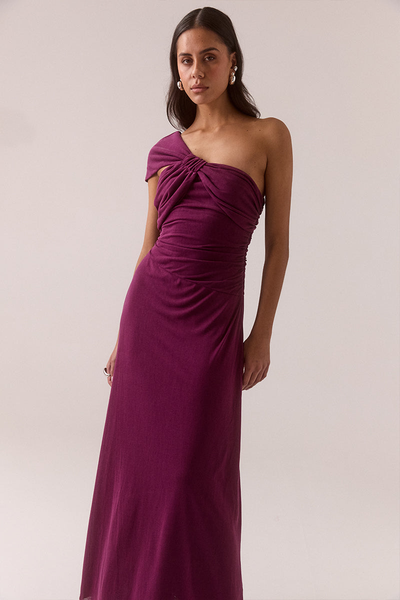 Asymmetric neckline stretch modal blend maxi dress with fitted dropped waist, gathered waist and shoulder details, internal bralette and invisible side zipper, worn by model in size 8.
