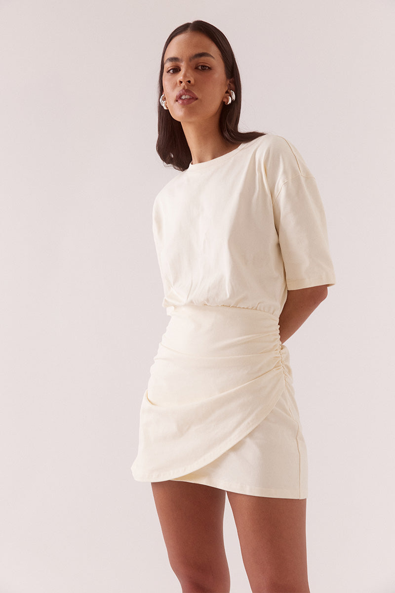 Women’s oversized cotton tee mini dress with dropped shoulders, crew neck, wrap skirt detail, soft gathers at waist, and side zip closure.