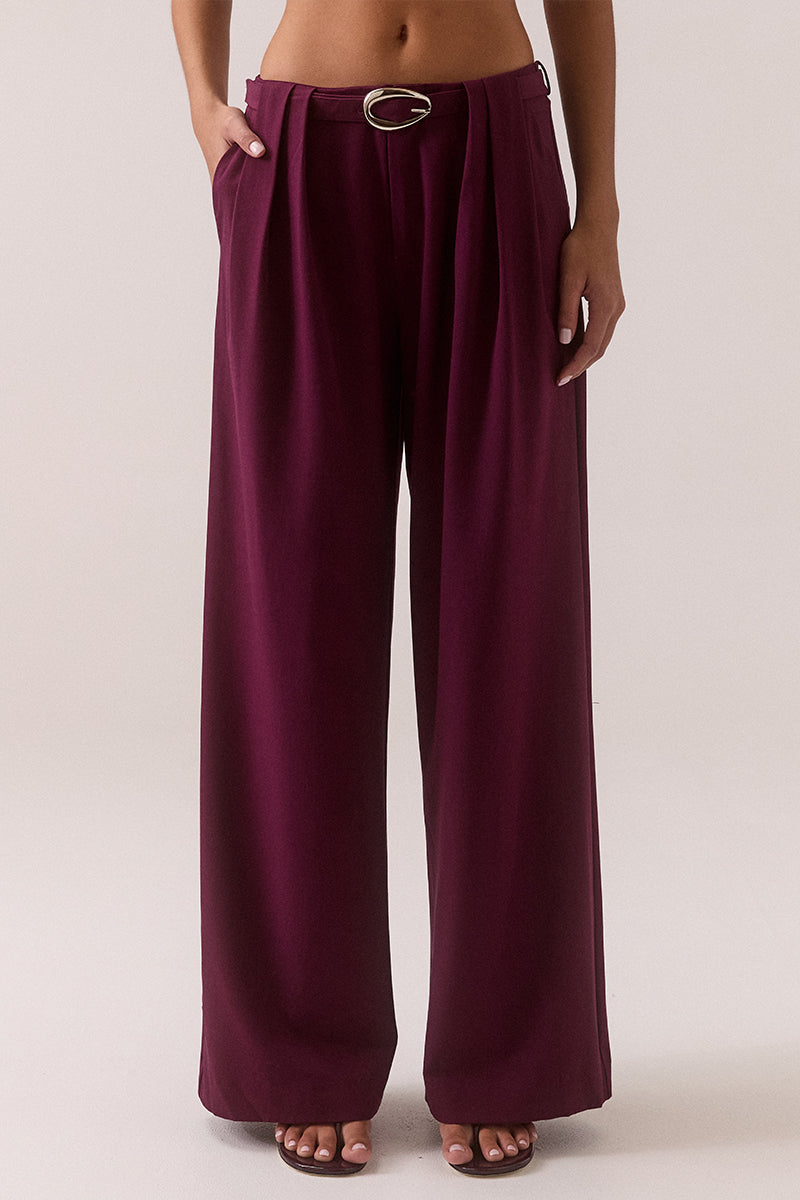 Mid rise wide-leg stretch rayon blend pants with front pleats, removable belt with silver buckle, angled front pockets and back welt pockets.