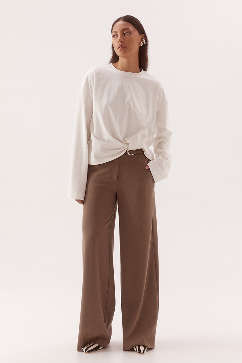 Women's oversized cotton long sleeve tee with dropped shoulders, crew neckline, and tucked front detail creating a flattering shaped hem.