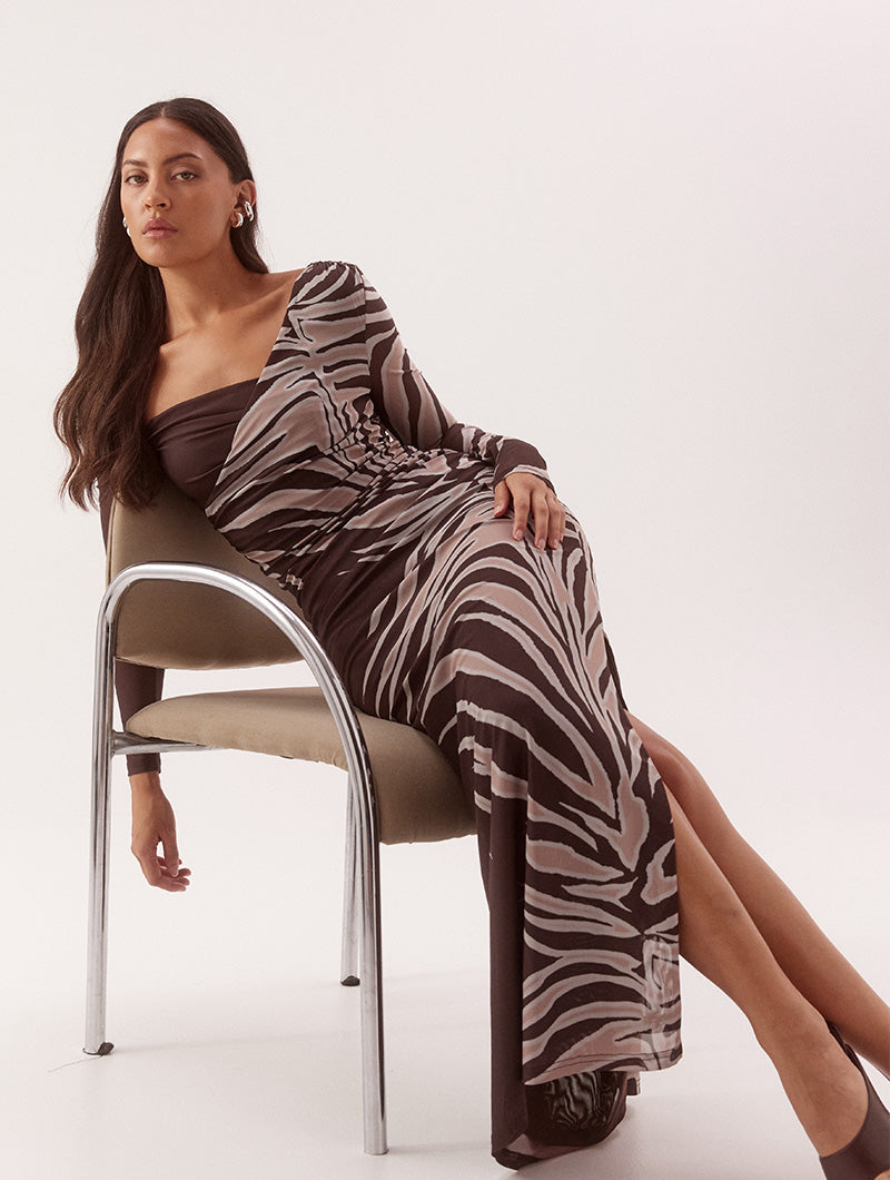 Women's fitted stretch mesh midi dress in exclusive print with asymmetric off-shoulder neckline, ruched bodice, long sleeves, and side split detail.