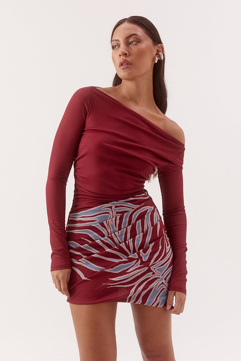 Women's fitted stretch mesh mini dress in exclusive print with a boat neckline, gathered waist detailing, layered skirt, and soft bubble hem.