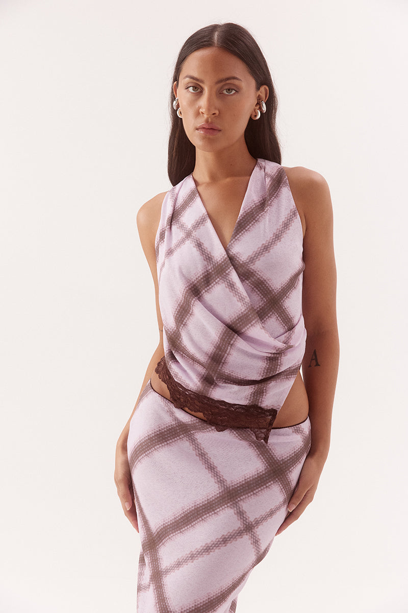 Women's exclusive print textured stretch mesh sleeveless wrap top with gathered sides, asymmetric lace-trim hem and pull-on design.
