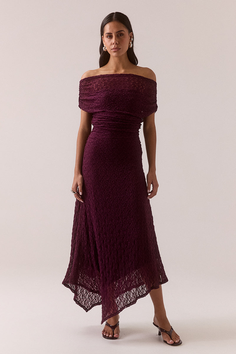 Off shoulder stretch lace midi dress with asymmetric hem, gathered waist and shoulders, internal bralette lining and left side split, worn by model in size 8.