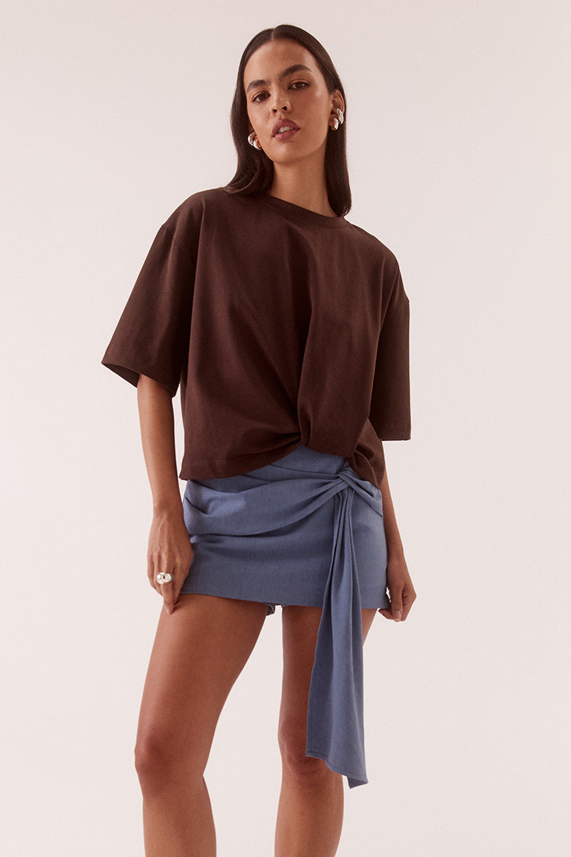 Women’s oversized cotton tee with dropped shoulders, crew neck, mid-length sleeves, and tucked front detail creating a shaped hem.