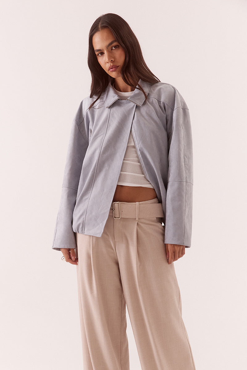 Women’s faux suede bomber jacket with dropped shoulders, front zip closure, welt pockets, chest zip detail, and elasticated hem finish.