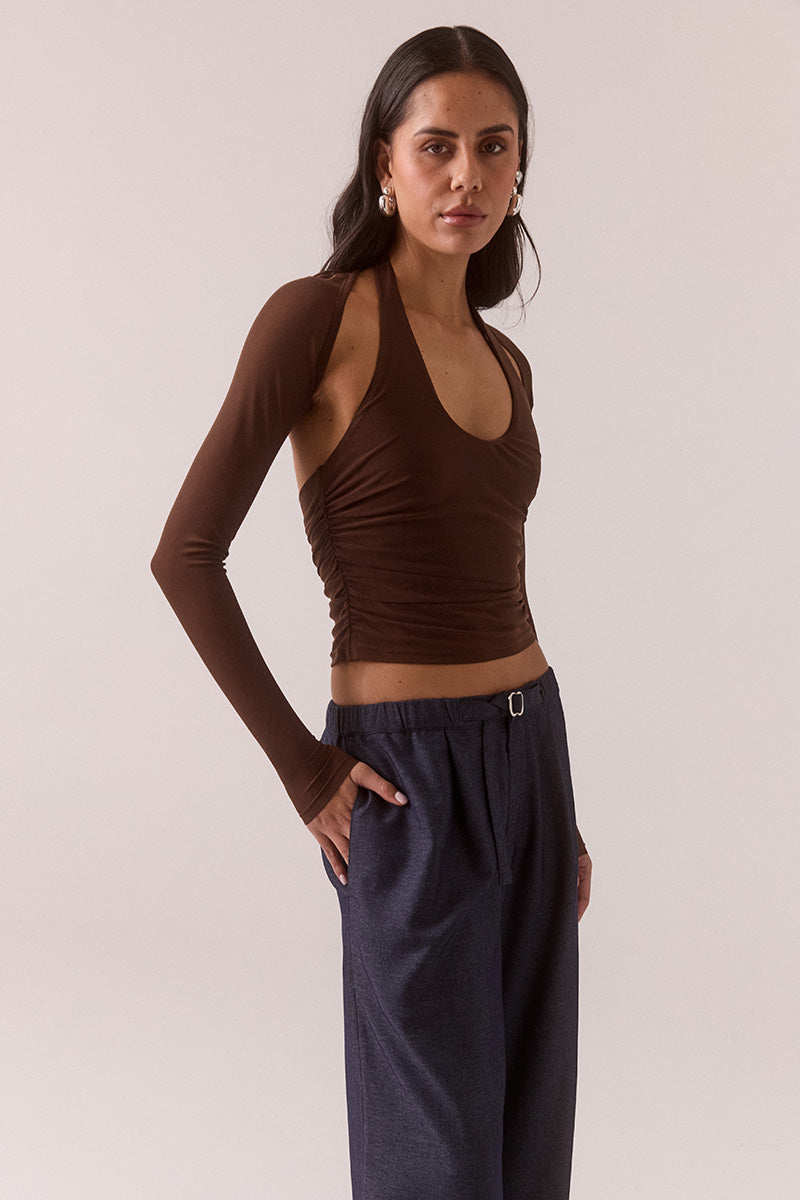 Model wearing stretch mesh two-piece maxi dress with halter neck top, long sleeve bolero, scoop neckline, built-in bralette support, side ruching, and fully lined non-sheer body-contouring fit.