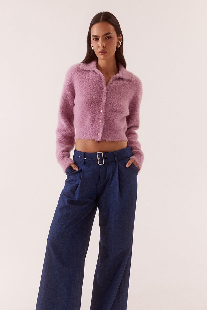 Model wearing a fluffy knit cardigan with collar, short buttoned front, long sleeves, dropped shoulders and fitted ribbed hem and cuffs.