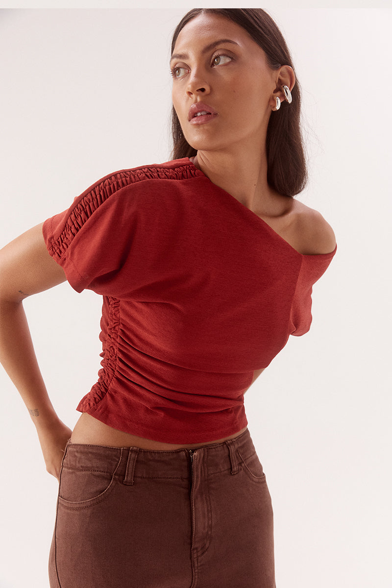Textured mesh off shoulder top with asymmetric neckline, gathered waist, short sleeves and versatile shoulder styling