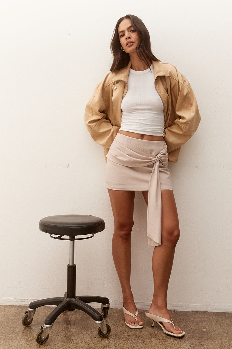 Women’s faux suede bomber jacket with dropped shoulders, front zip closure, welt pockets, chest zip detail, and elasticated hem finish.