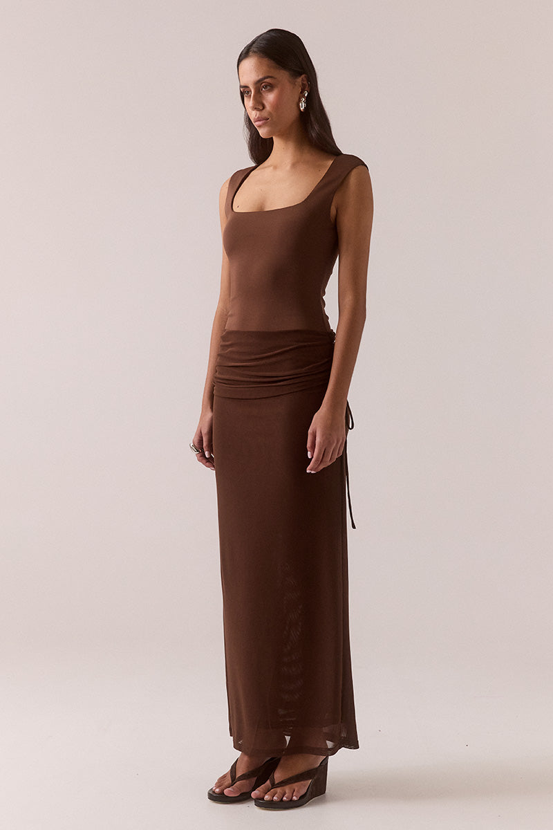 Model wearing stretch mesh two-piece maxi dress with halter neck top, long sleeve bolero, scoop neckline, built-in bralette support, side ruching, and fully lined non-sheer body-contouring fit.