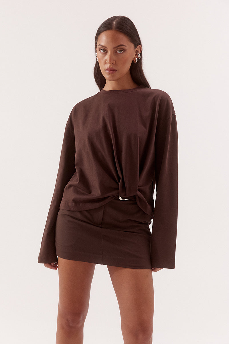 Women's oversized cotton long sleeve tee with dropped shoulders, crew neckline, and tucked front detail creating a flattering shaped hem.