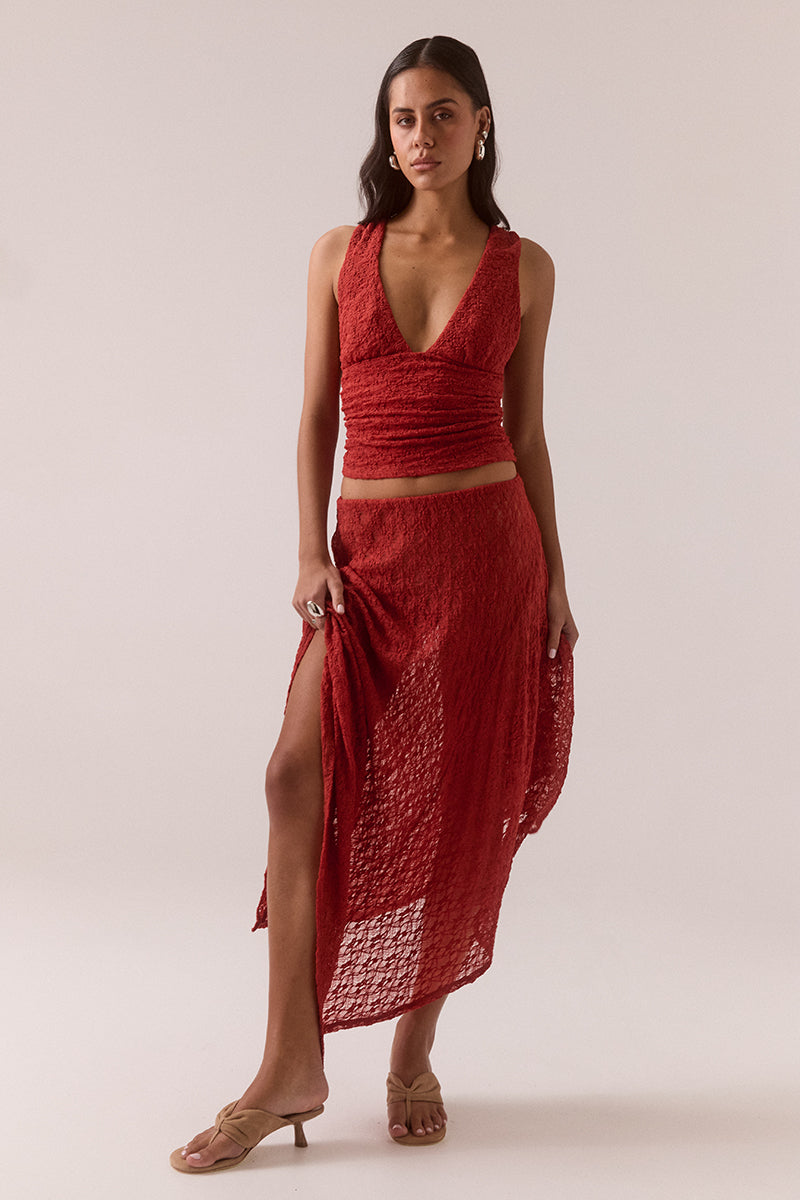 Mid rise stretch lace midi skirt with double layer construction, removable mesh lining, asymmetric hem and circle cut godet panel at side, worn by model in size 8.