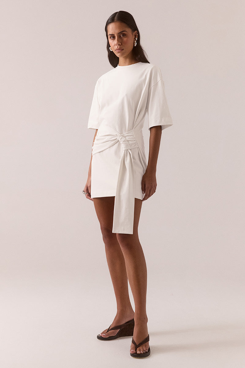 Relaxed fit 100% cotton mini T-shirt dress with crew neckline, dropped shoulders, side-gathered sash with loop detail, worn by model in size 8.