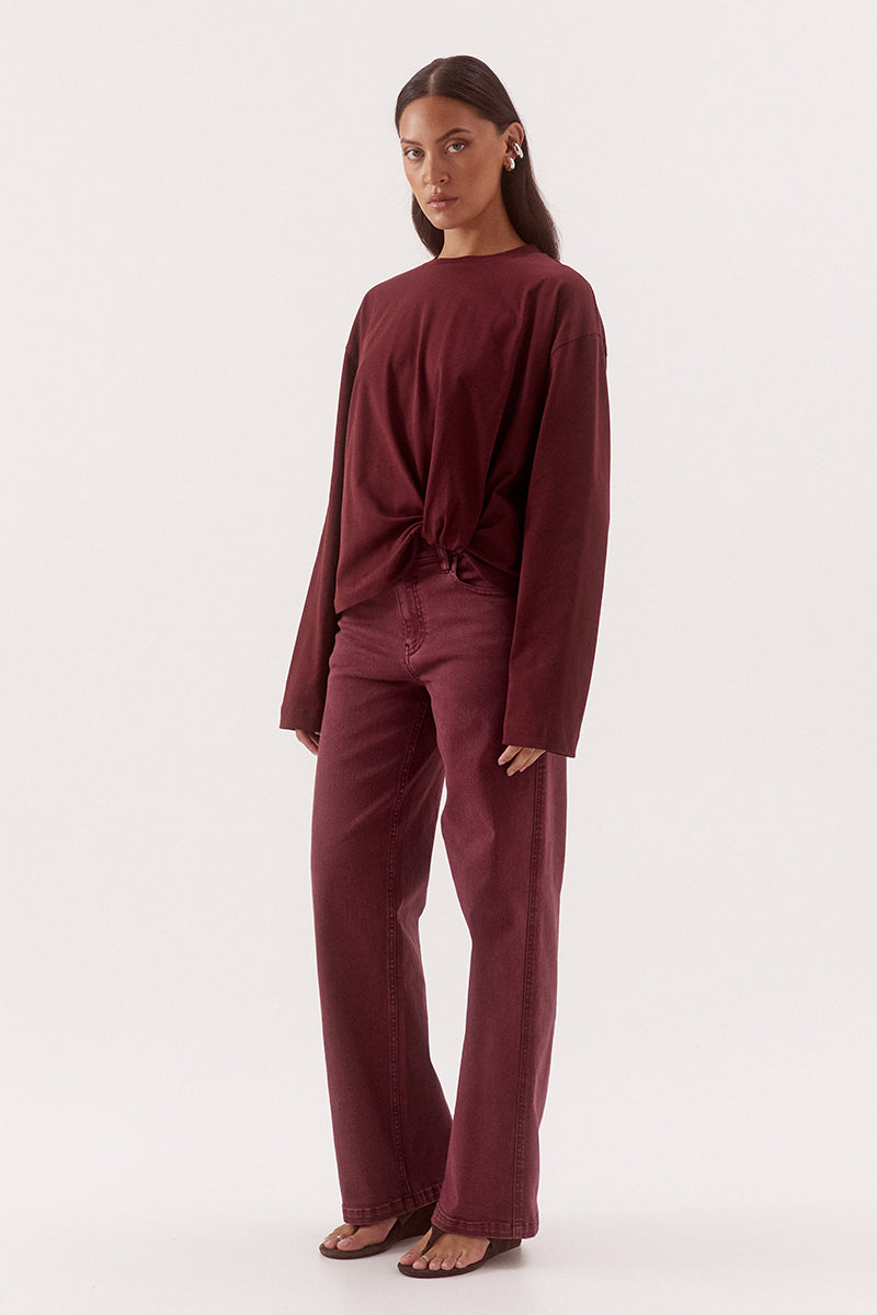 Women's oversized cotton long sleeve tee with dropped shoulders, crew neckline, and tucked front detail creating a flattering shaped hem.