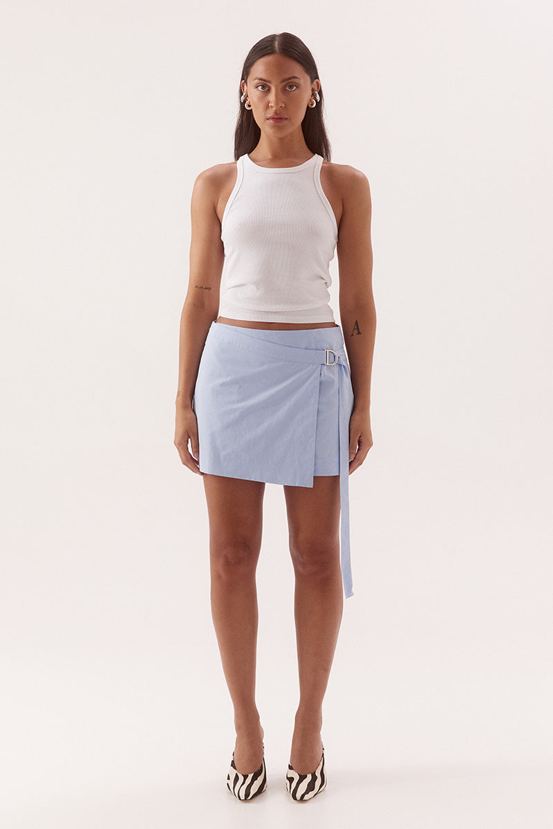 Women's cotton matching shirt and mini skirt set featuring relaxed fit shirt with chest pockets, and wrap-style A-line skirt with adjustable belt detail.