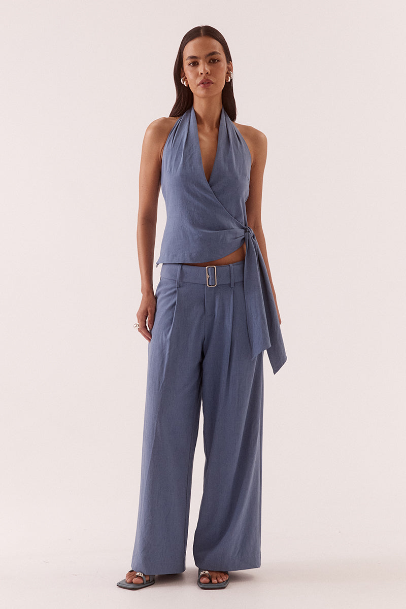Women’s mid-rise wide leg pants in stretch rayon blend with front tucks, removable belt, angled pockets, and tailored fit with fly closure.