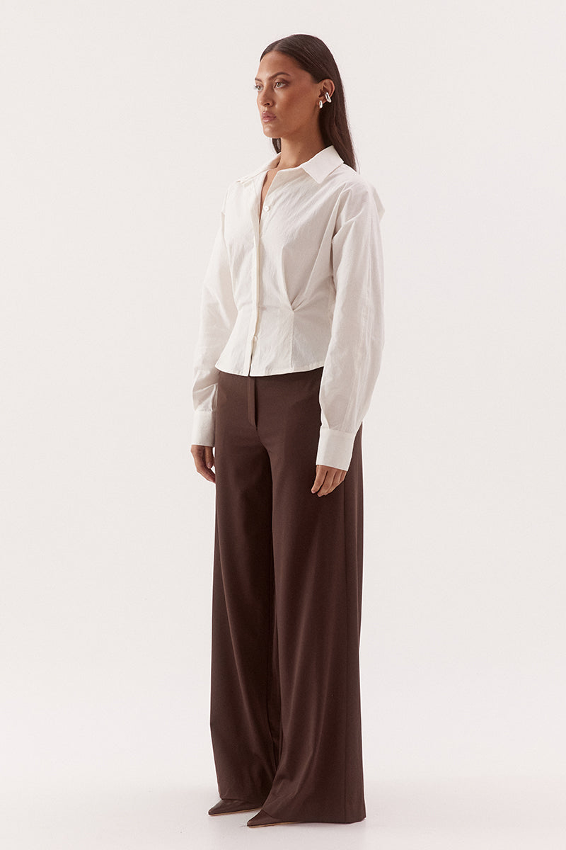 Women's cotton blend long sleeve shirt with a cinched waist, barrel sleeves, concealed button front, two-piece collar, and shaping seam details.