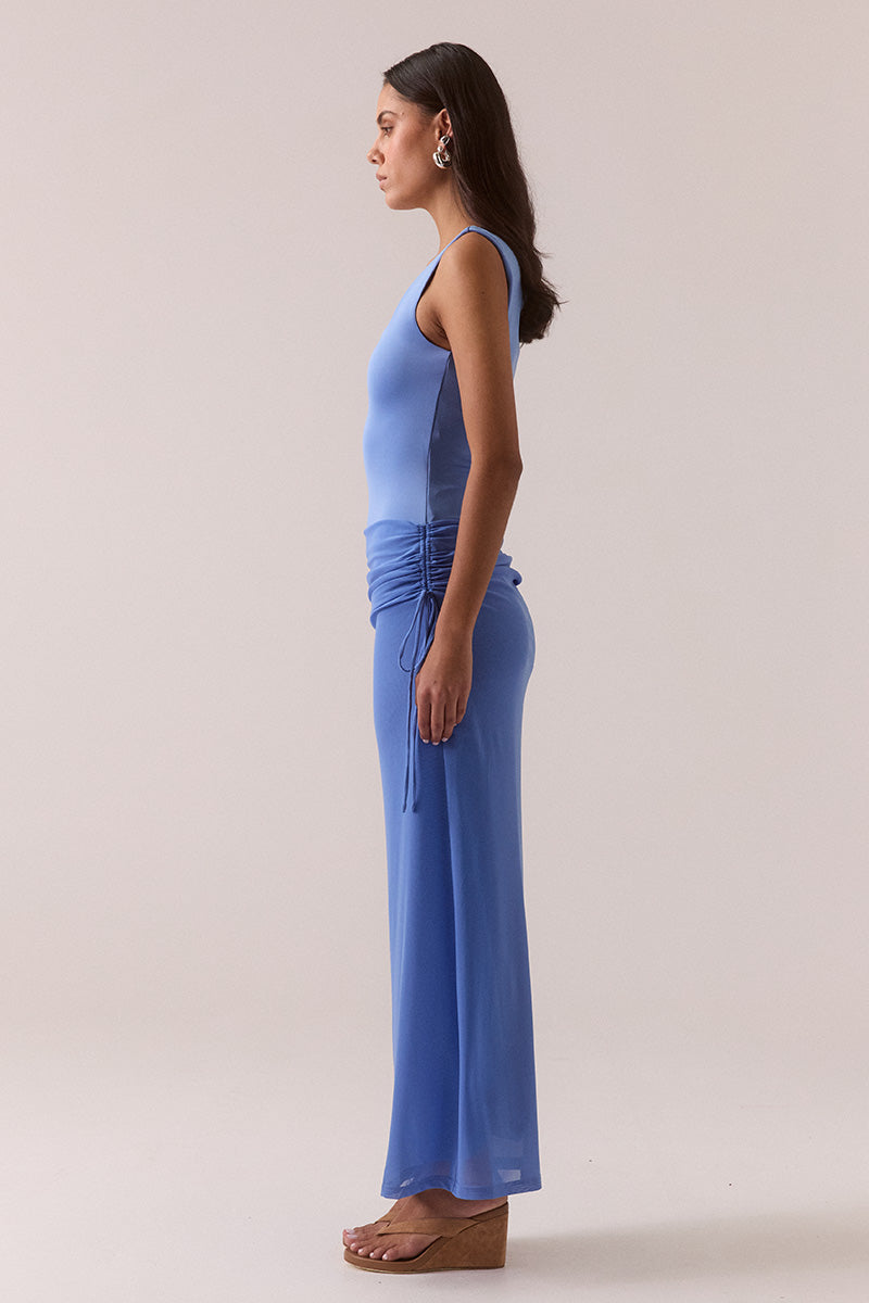 Model wearing dropped waist maxi dress with wide square neckline, stretch bodice, adjustable hip drawstring, fully lined mesh skirt, and elongating pull-on silhouette.