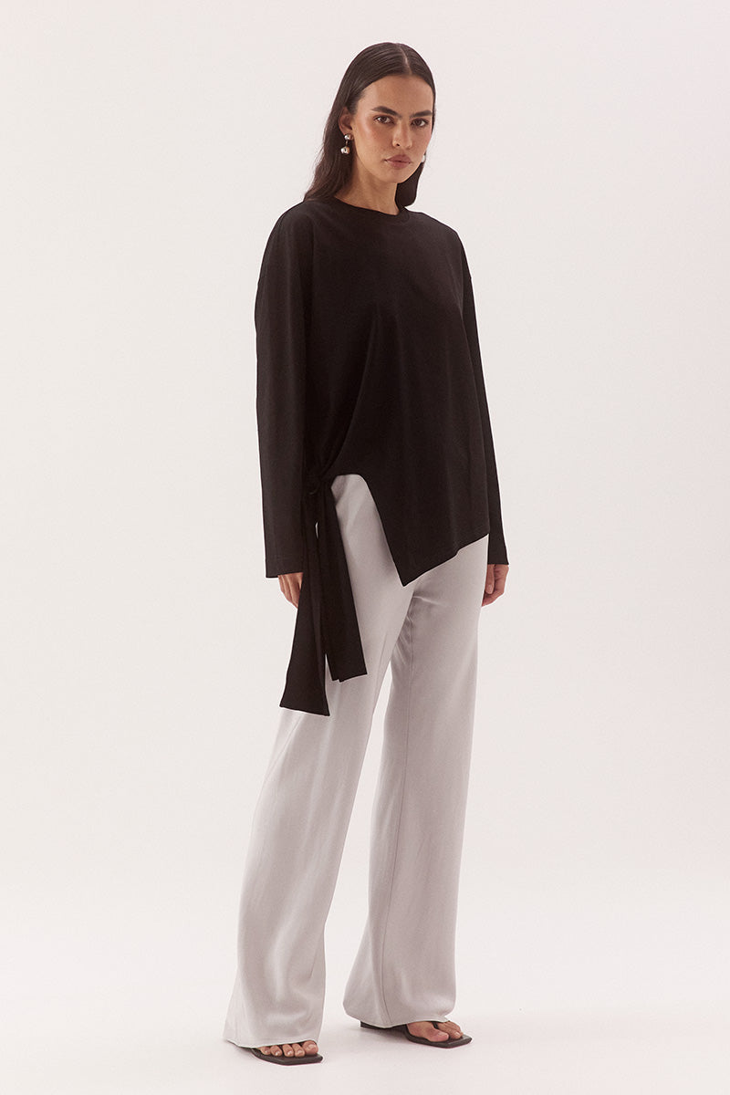 Women's oversized long sleeve cotton tee with dropped shoulders, crew neck, tie-side detail, and relaxed fit. Model wears size 8 and is 178cm tall.