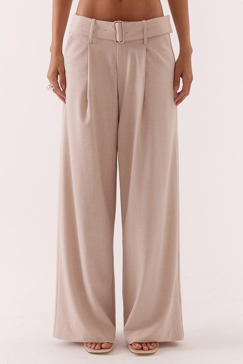 Women’s mid-rise wide leg pants in stretch rayon blend with front tucks, removable belt, angled pockets, and tailored fit with fly closure.