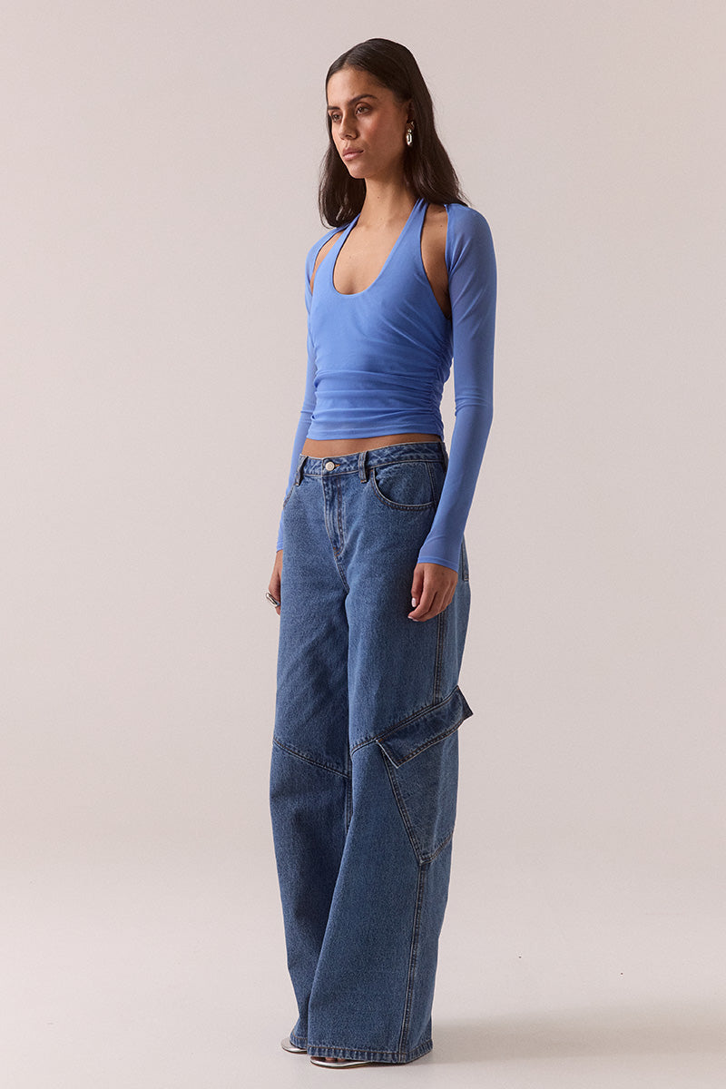 Model wearing stretch mesh two-piece maxi dress with halter neck top, long sleeve bolero, scoop neckline, built-in bralette support, side ruching, and fully lined non-sheer body-contouring fit.