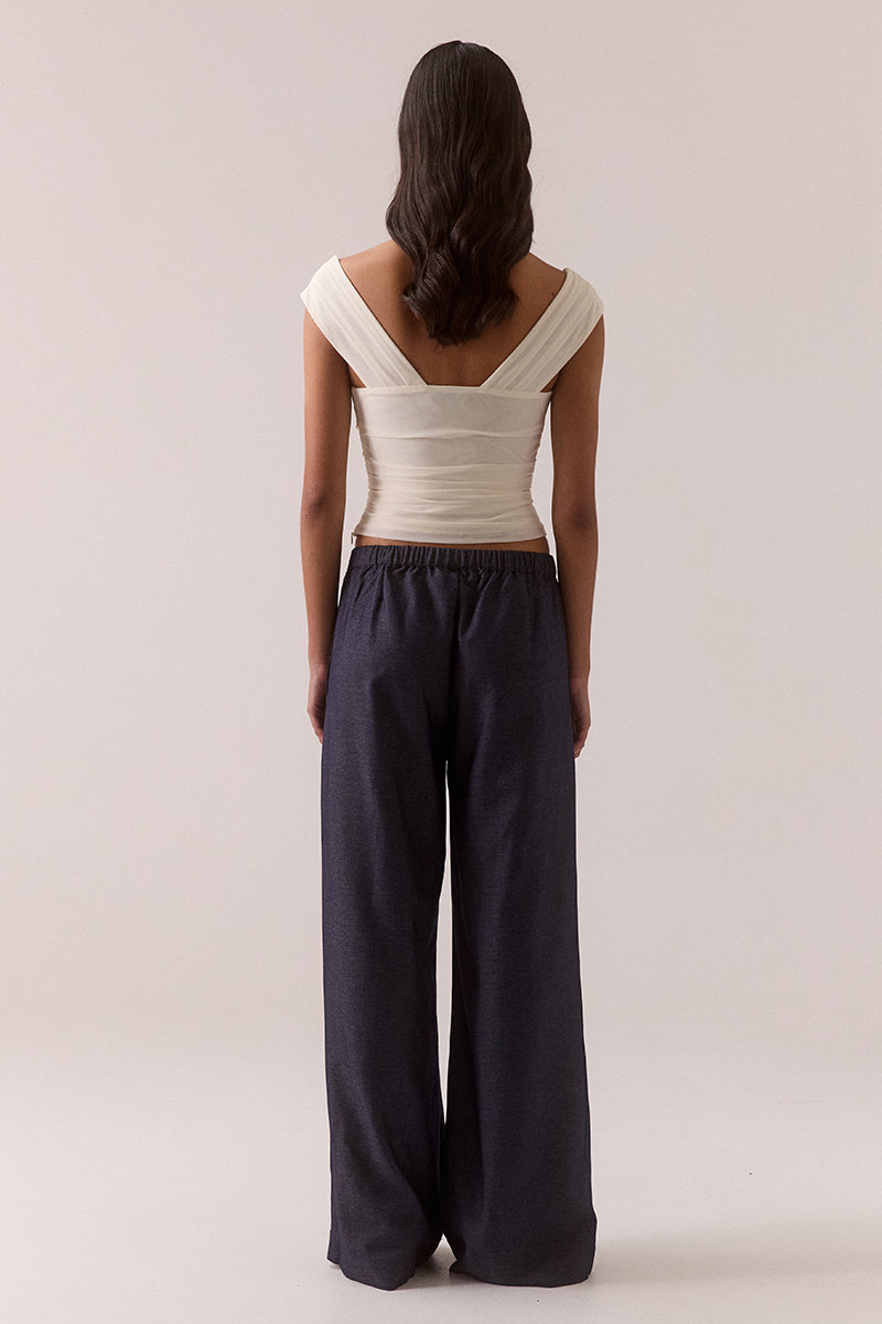 Sleeveless stretch mesh top with wide scoop neckline and fitted silhouette