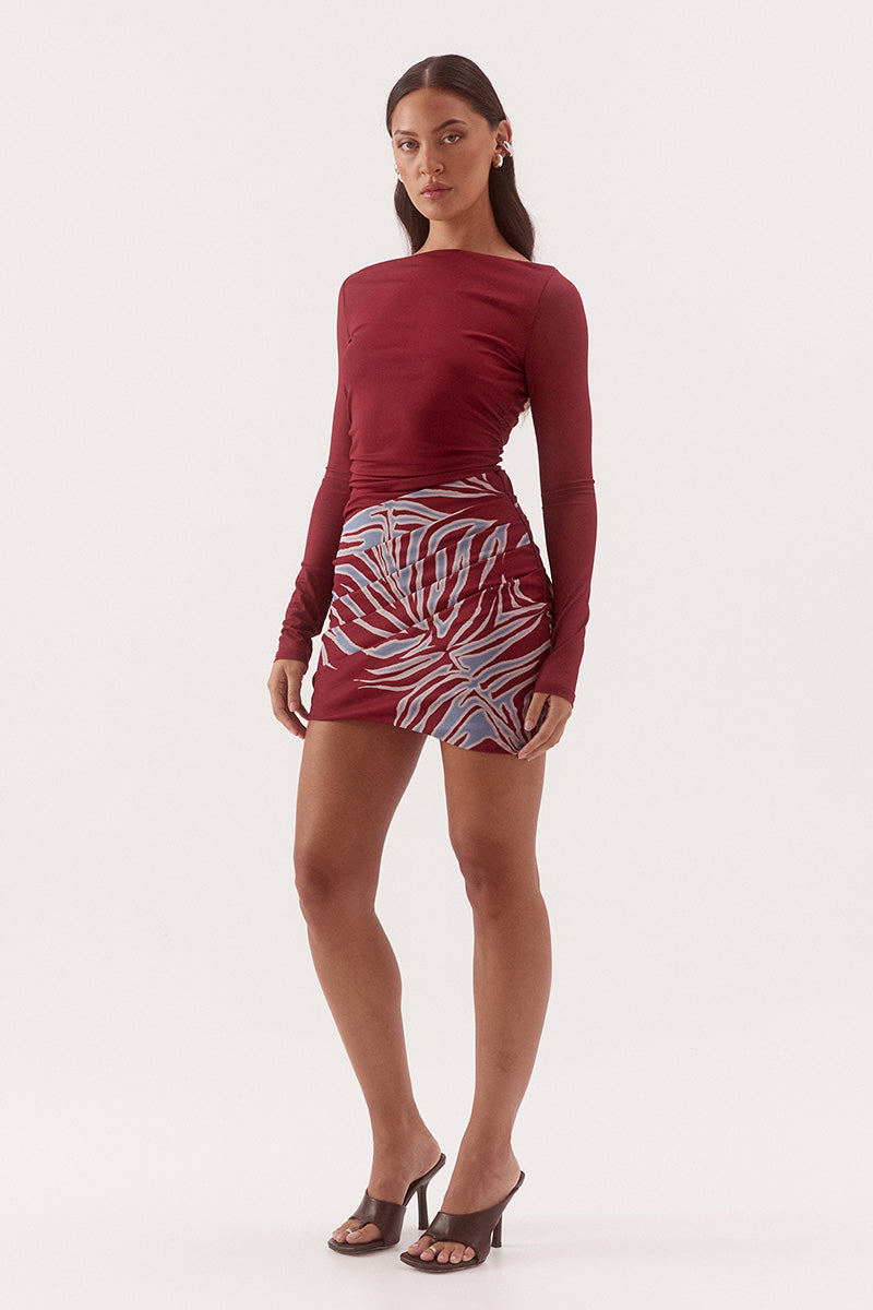 Women's fitted stretch mesh mini dress in exclusive print with a boat neckline, gathered waist detailing, layered skirt, and soft bubble hem.