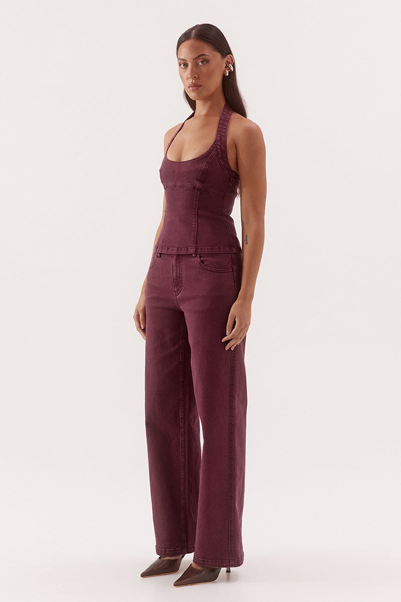 Women's cotton blend denim halter mini dress with scoop neckline, empire waist, princess seam detailing, and open-back zip closure.