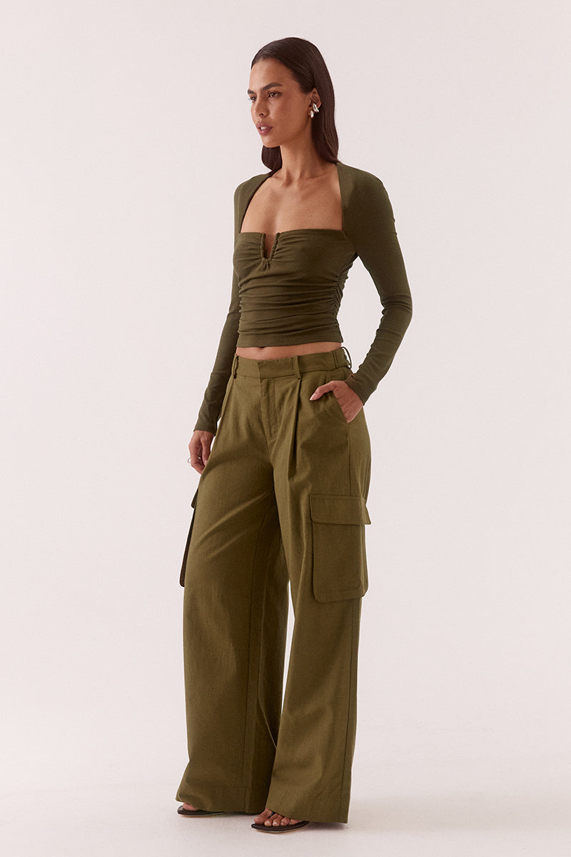 Textured stretch mesh sleeveless top with deep plunging neckline, lace trim, empire waist, and gathered front detail.