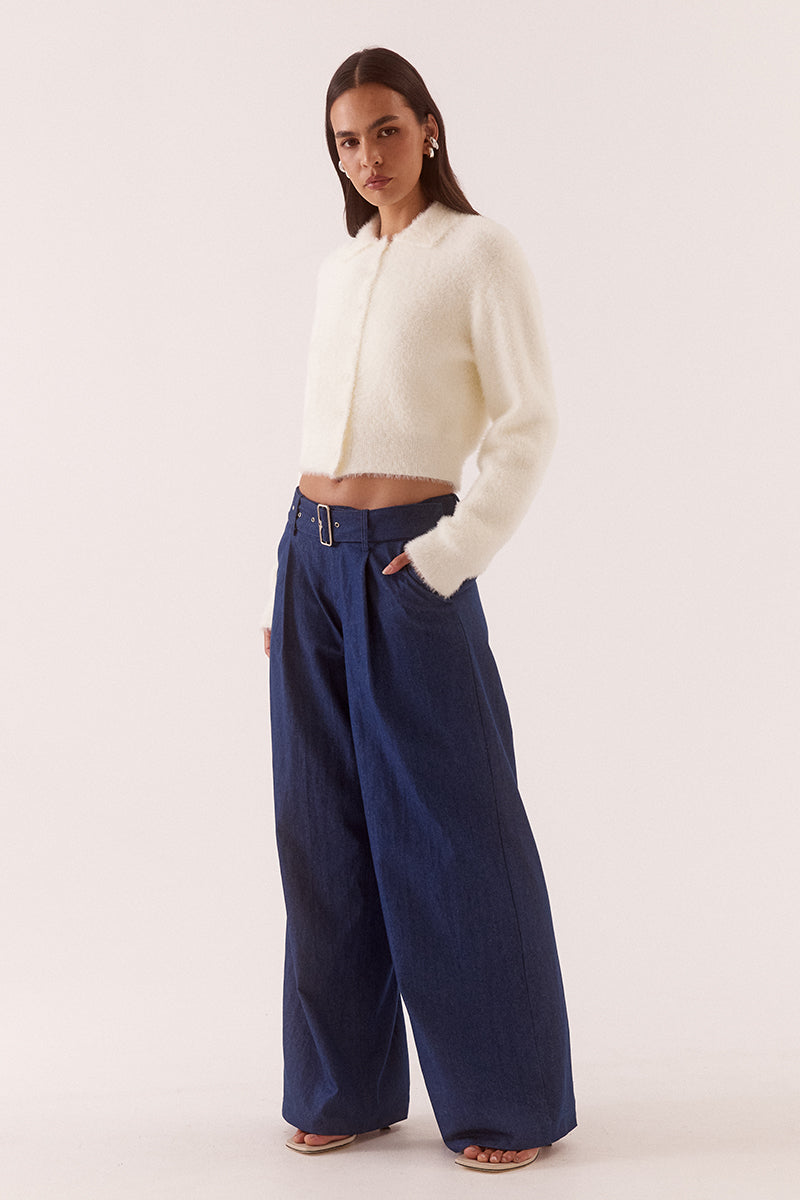 Model wearing a fluffy knit cardigan with collar, short buttoned front, long sleeves, dropped shoulders and fitted ribbed hem and cuffs.