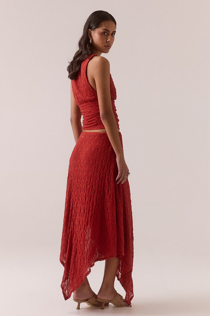 Mid rise stretch lace midi skirt with double layer construction, removable mesh lining, asymmetric hem and circle cut godet panel at side, worn by model in size 8.