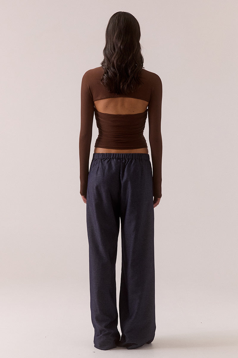Model wearing stretch mesh two-piece maxi dress with halter neck top, long sleeve bolero, scoop neckline, built-in bralette support, side ruching, and fully lined non-sheer body-contouring fit.