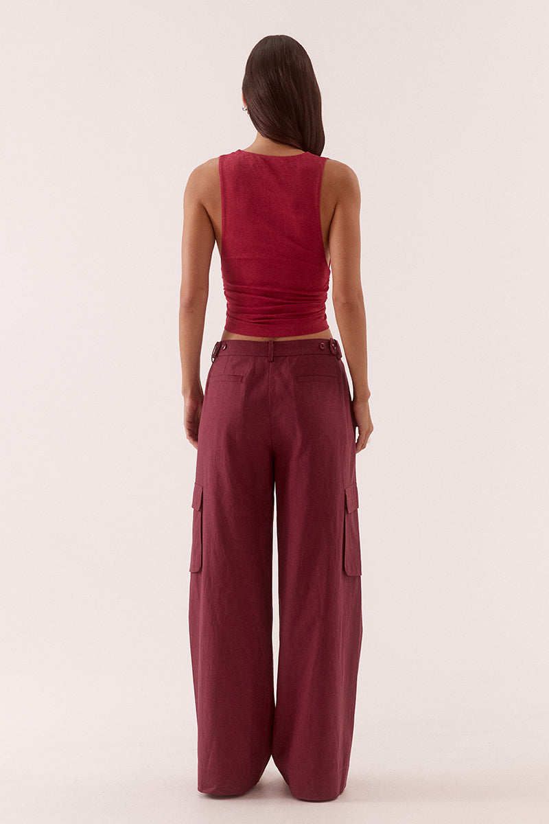 Textured stretch mesh sleeveless top with deep plunging neckline, lace trim, empire waist, and gathered front detail.