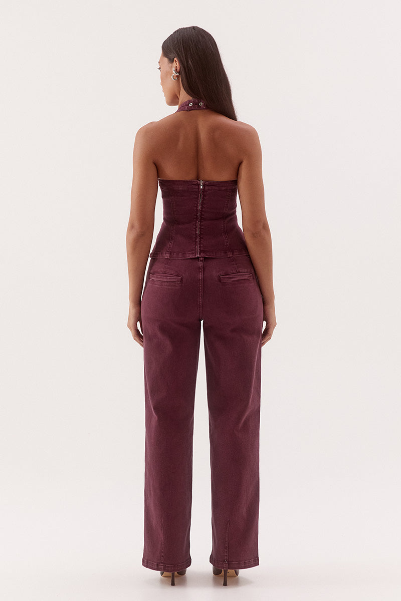 Women's cotton blend denim halter mini dress with scoop neckline, empire waist, princess seam detailing, and open-back zip closure.