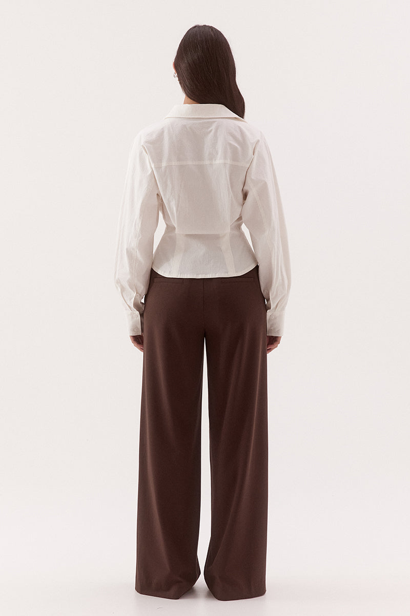 Women's cotton blend long sleeve shirt with a cinched waist, barrel sleeves, concealed button front, two-piece collar, and shaping seam details.