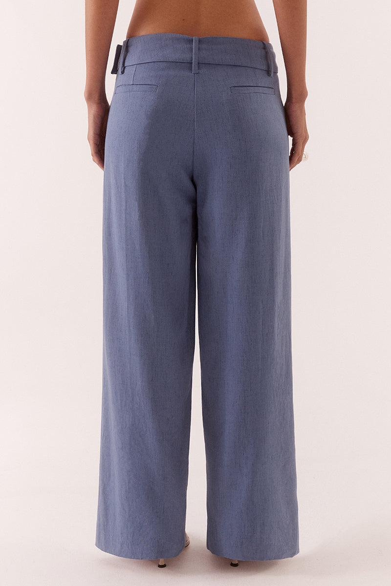 Women’s mid-rise wide leg pants in stretch rayon blend with front tucks, removable belt, angled pockets, and tailored fit with fly closure.