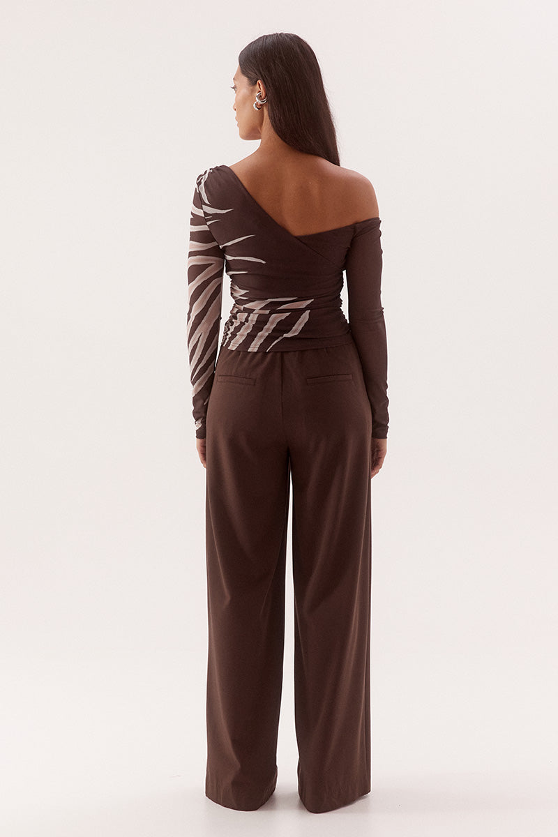 Women's fitted stretch mesh long sleeve top in exclusive print with asymmetric off-shoulder neckline, ruching detail, and body-lined finish.