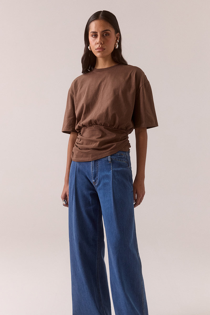 Relaxed fit 100% cotton T-shirt with crew neckline, dropped shoulders, asymmetrical drape hem layer and side invisible zipper, worn by model in size 8.