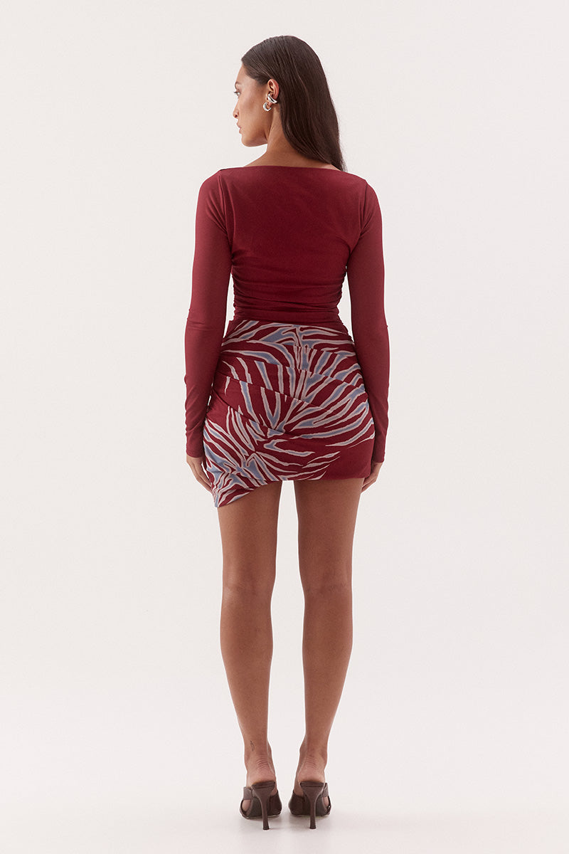 Women's fitted stretch mesh mini dress in exclusive print with a boat neckline, gathered waist detailing, layered skirt, and soft bubble hem.