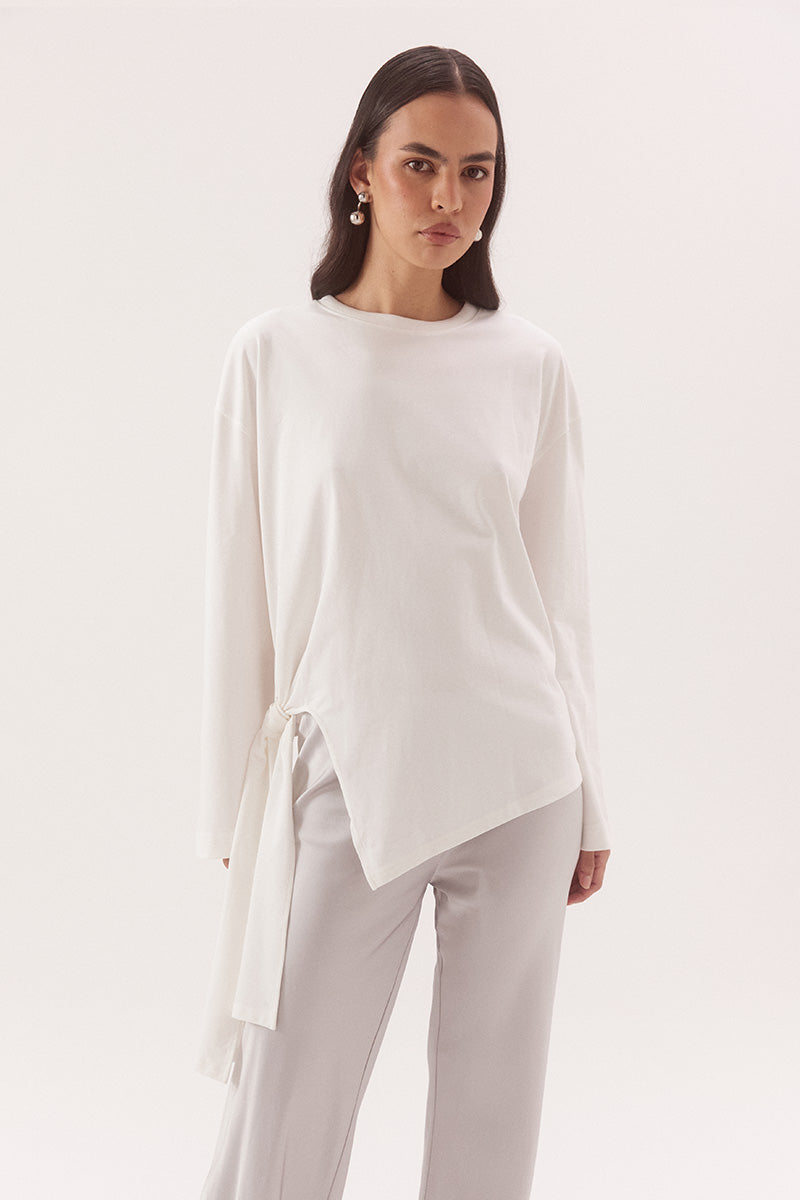 Women's oversized long sleeve cotton tee with dropped shoulders, crew neck, tie-side detail, and relaxed fit. Model wears size 8 and is 178cm tall.